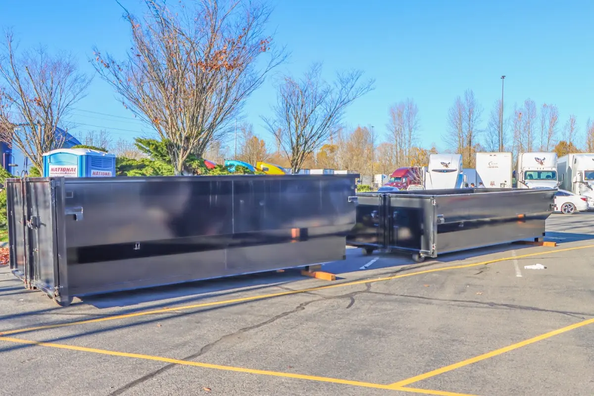 Professional dumpster rental service with roll-off container on residential driveway in Mulvane